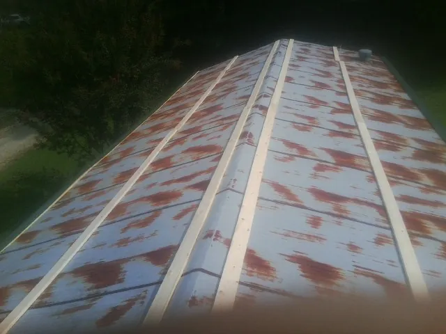 Rusted metal roof panels with new wood purlins before replacement — Storm Damage Roof Repair in Centerport by Roofing Brothers